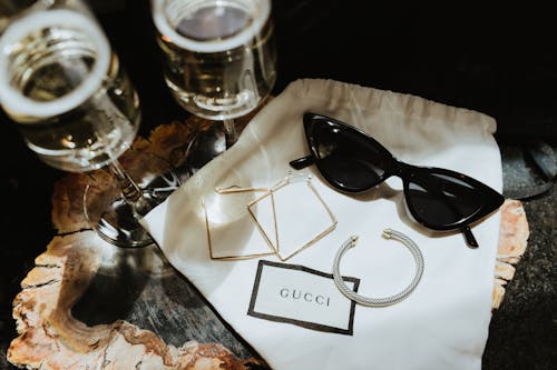 Free Black Framed Sunglasses on White Table Cloth Stock Photo