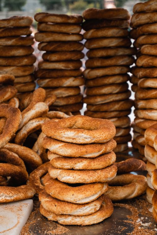 Free Delicious stacks of Turkish simit, freshly baked and arranged in piles, outdoors in Turkey. Stock Photo