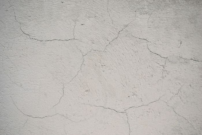 Fine shrinkage cracking across a plastered wall