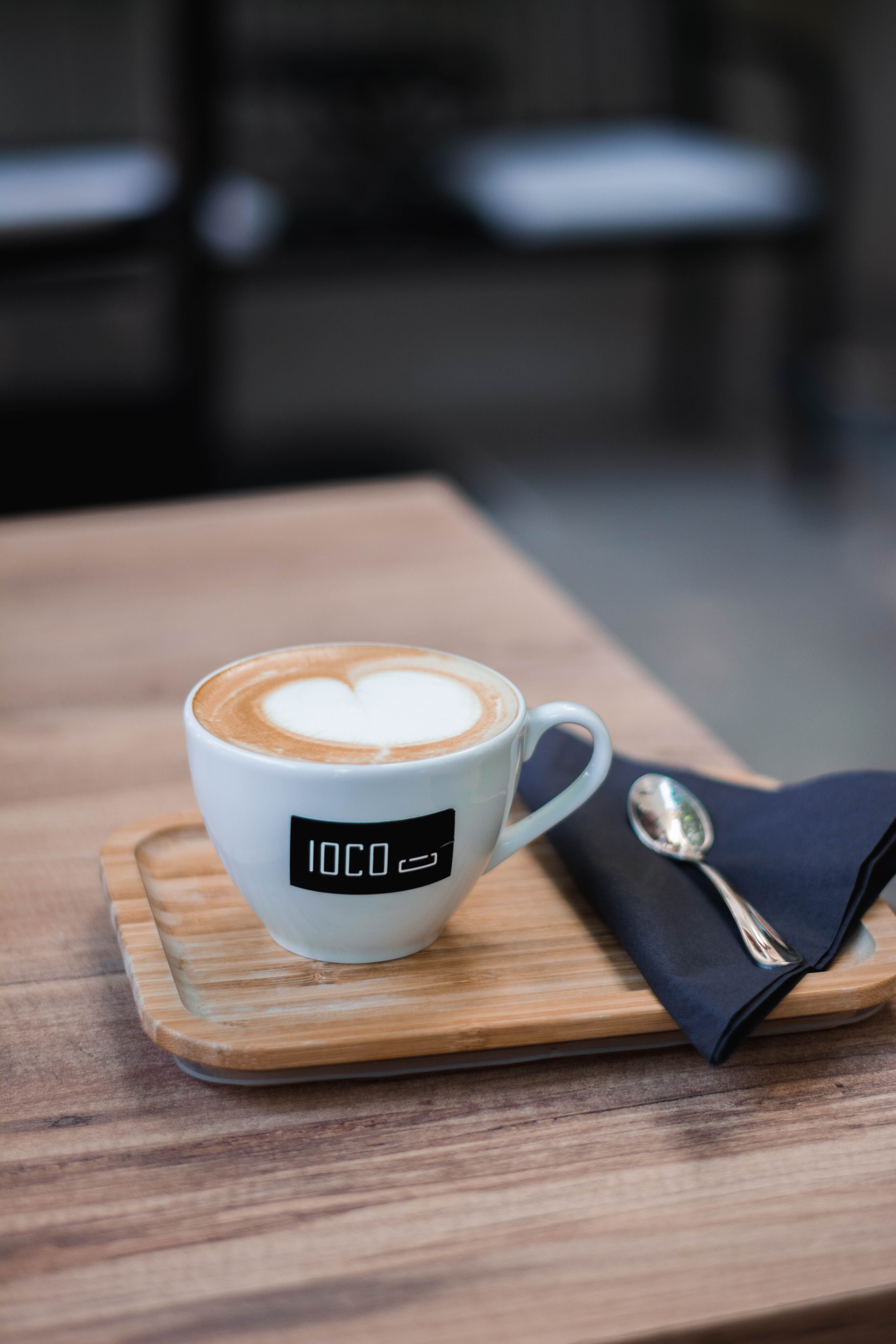 A close-up of a heart-shaped latte art in a café setting, perfect for coffee lovers.