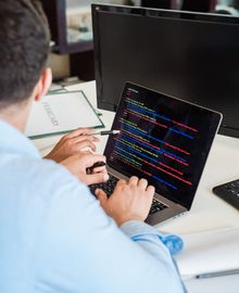 Developer building a web application on a laptop