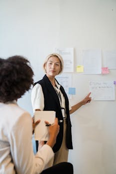 Two businesswomen in a discussion during a planning session at the office.