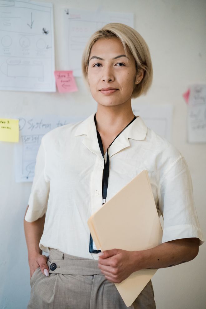 Fund manager holding documents in an office — photo by Mizuno K on Pexels