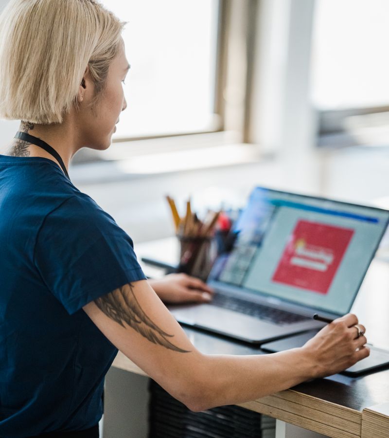 Creative professional using a laptop and stylus, photographed by Mizuno K on Pexels