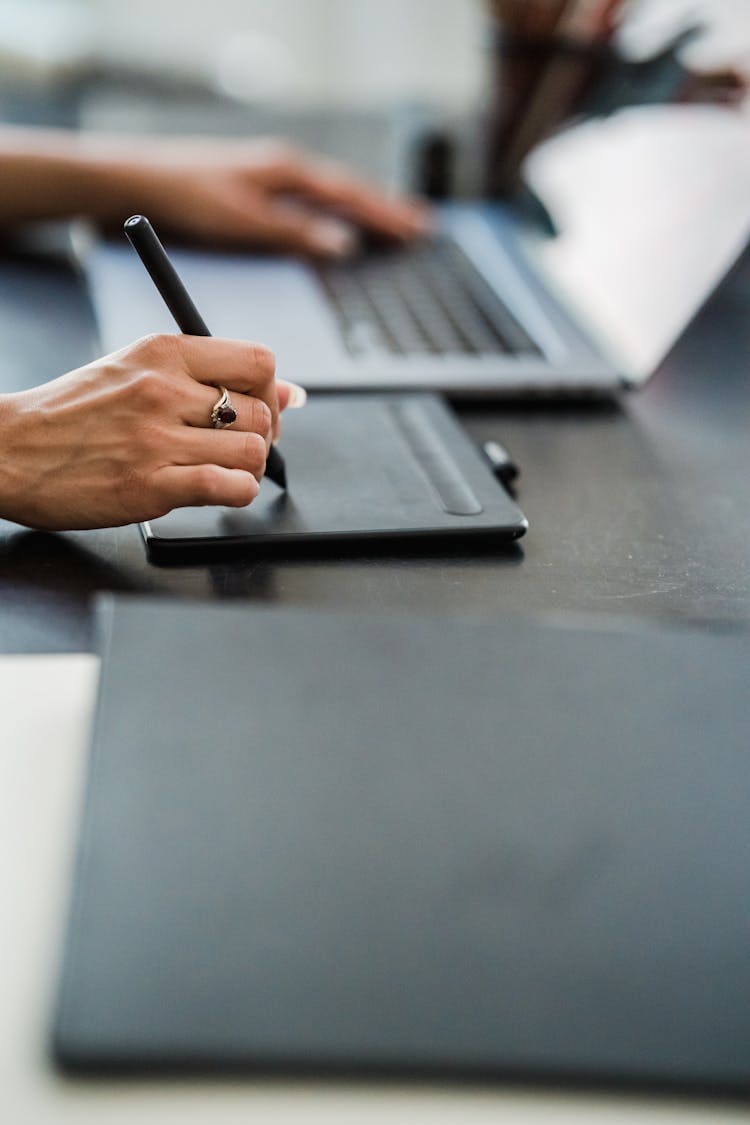 Close Up Of Woman Hands Writing On Professional Tablet