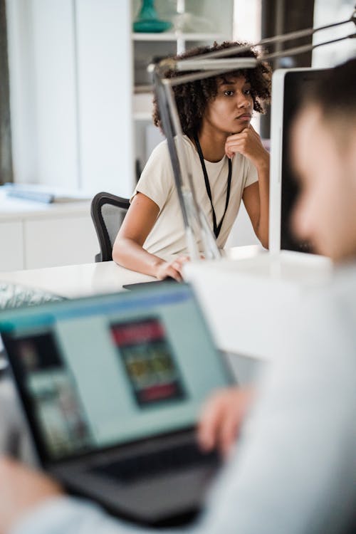 Man and Woman Working on Laptops in Office