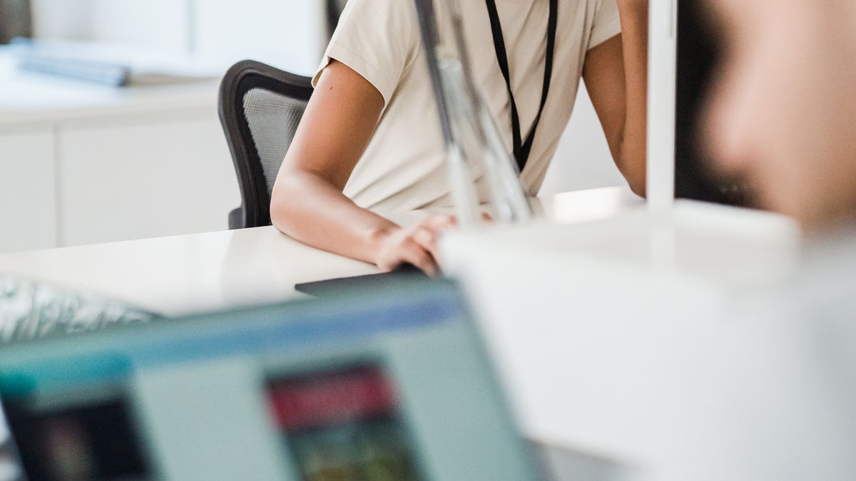 Colleagues discussing LinkedIn outreach strategy at a shared desk