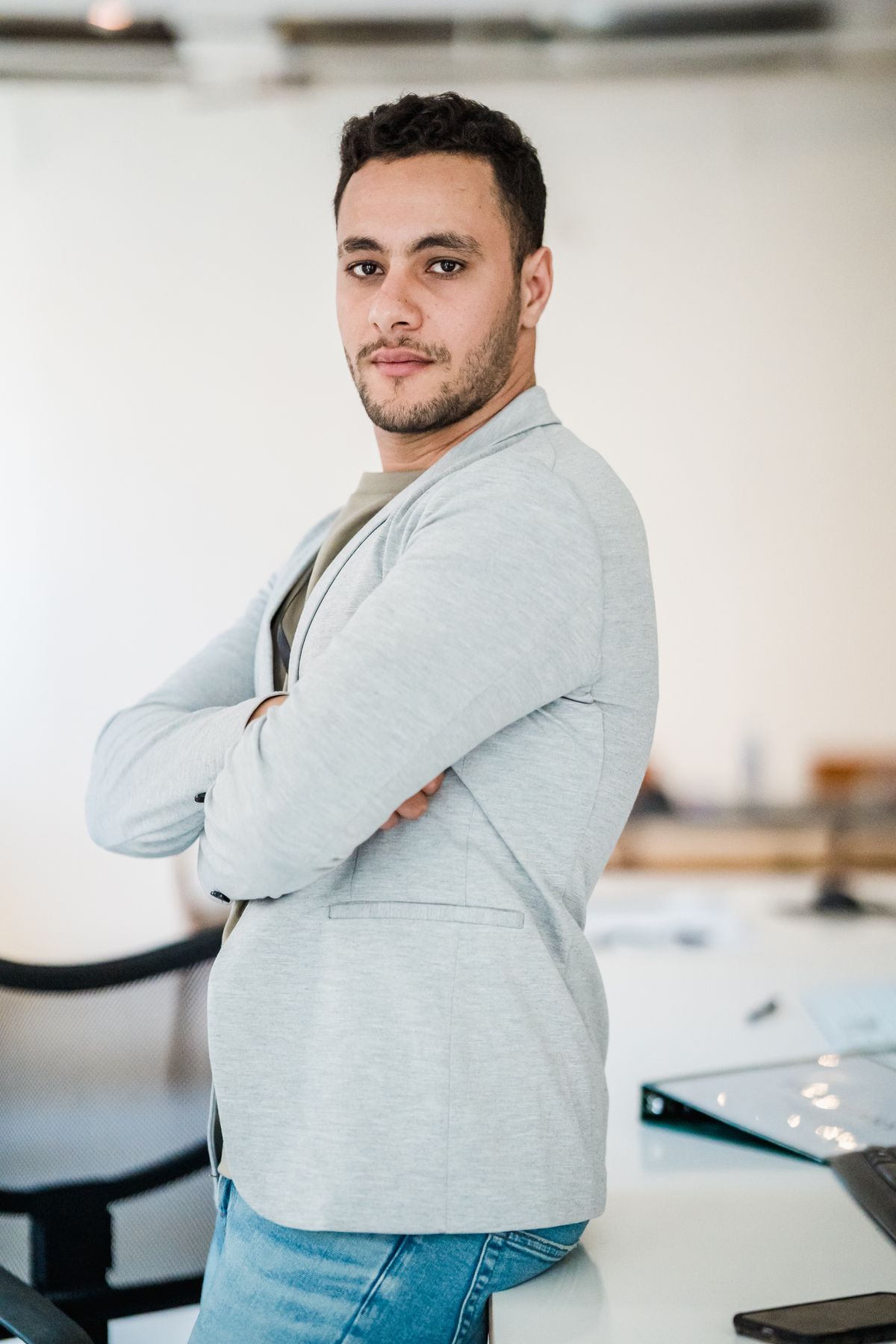 Portrait of a male creative director standing confidently in an office