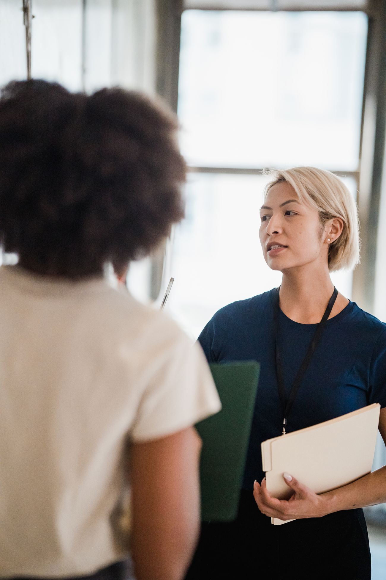 Two women discussing business documents together