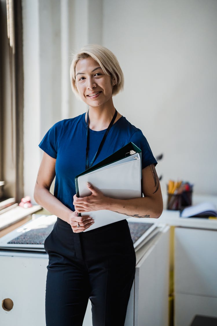 Woman Holding Binders At Office