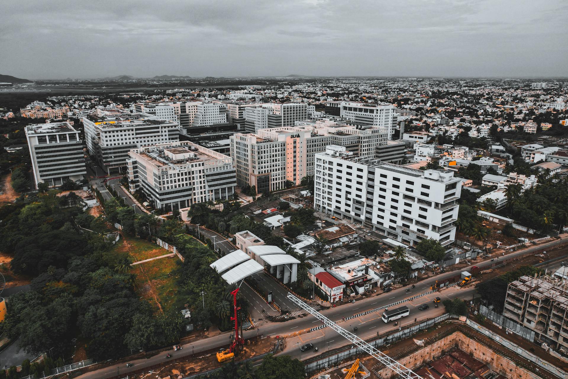 Drone shot capturing Chennai's bustling cityscape and modern architecture from above.