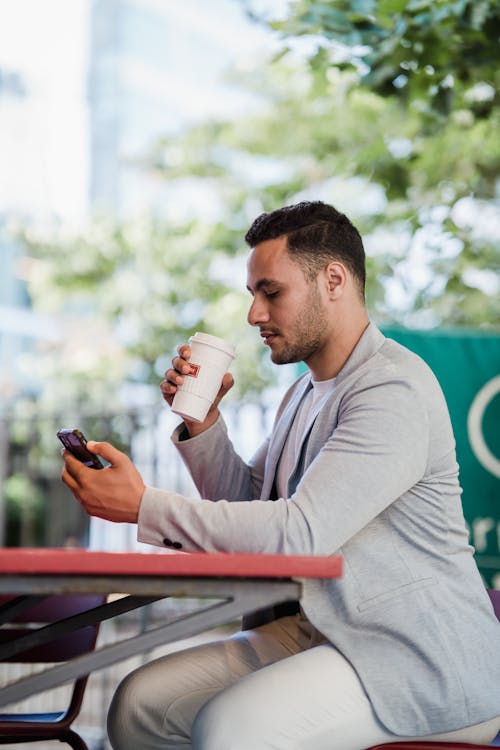 Man Using Smartphone on Lunch Break
