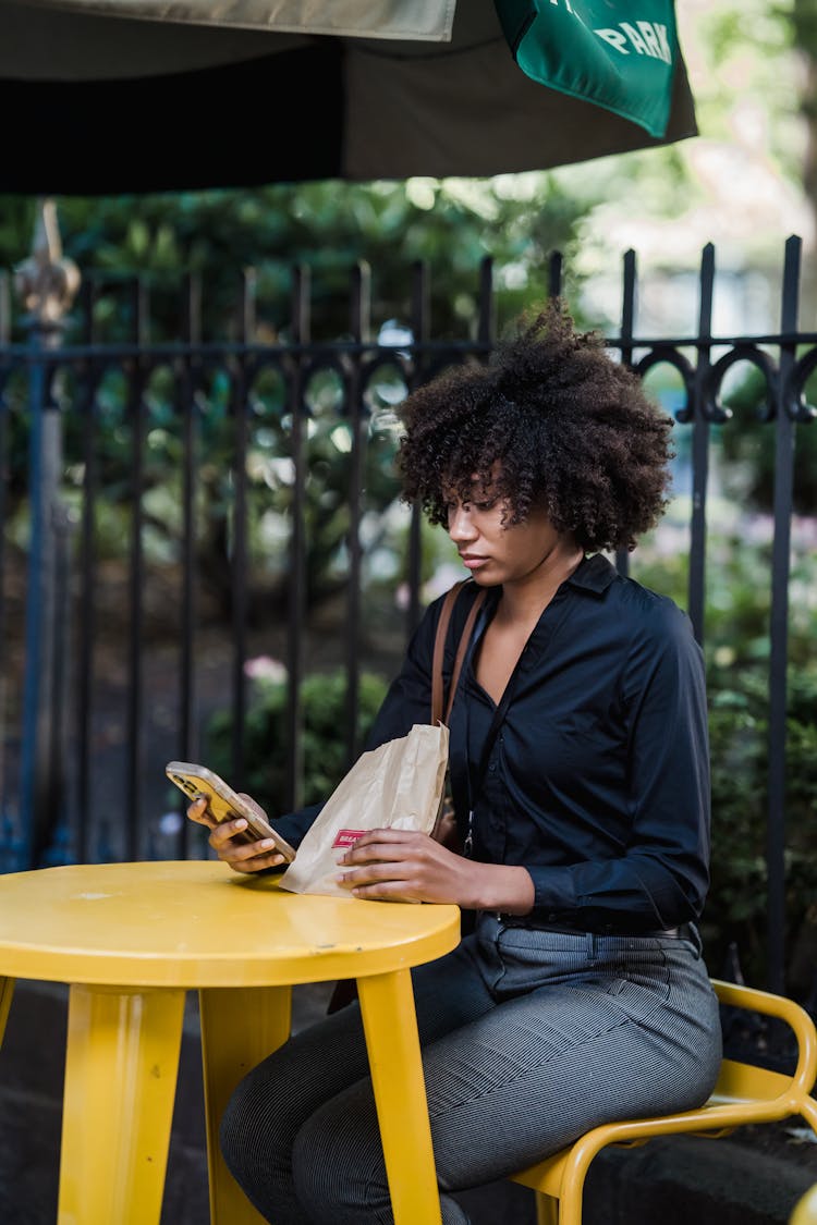 Woman Using Smart Phone On Lunch Break