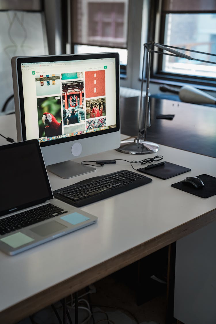 Empty Workplace In Office With PC And Laptop