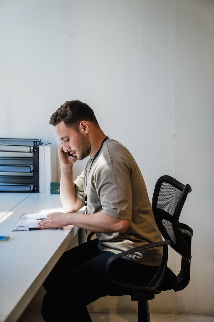 Man Talking On Phone In Office