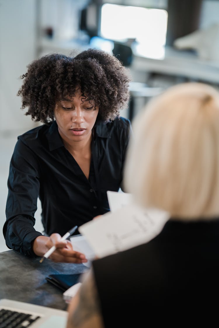 Women Discus Documents In Office