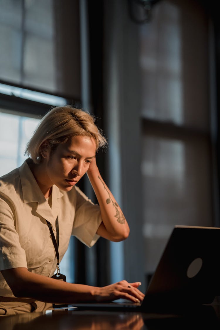 Woman Looking At Laptop Screen Thinking