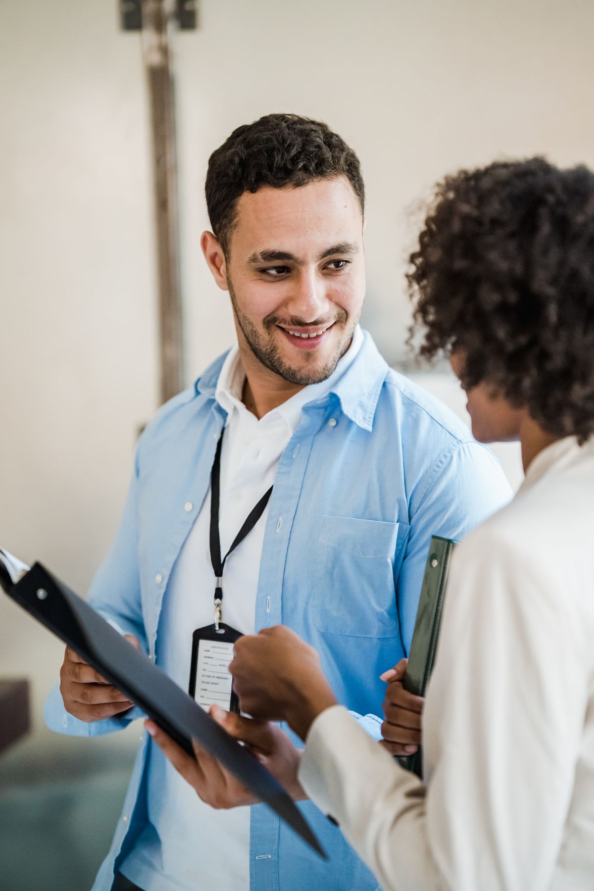 Two professionals reviewing paperwork in a modern office