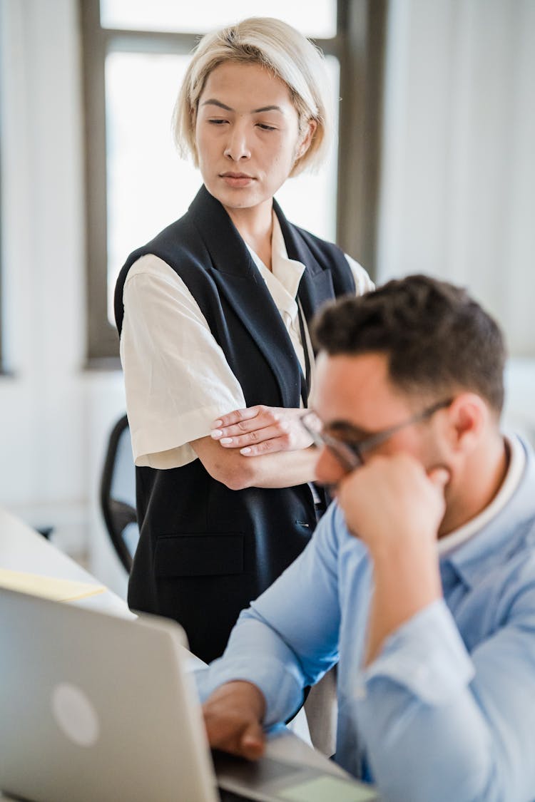 Businesswoman Supervising Employee In Office