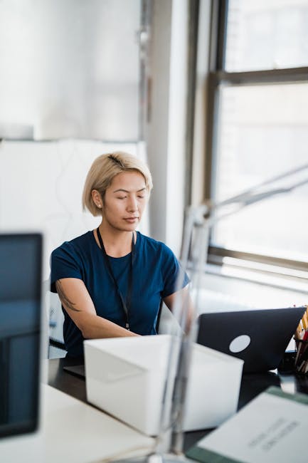 A focused professional intently reviewing a resume on a computer screen in a sleek, modern office setting, embodying the essence of job preparation and recruitment strategy.. Mizuno K with the shot
