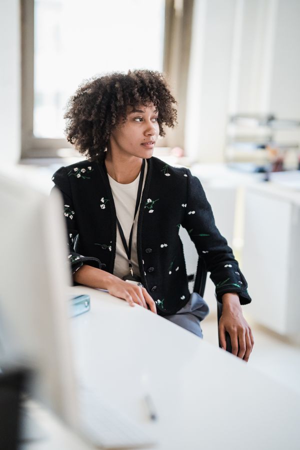 Woman in fine cardigan professional casual office outfit