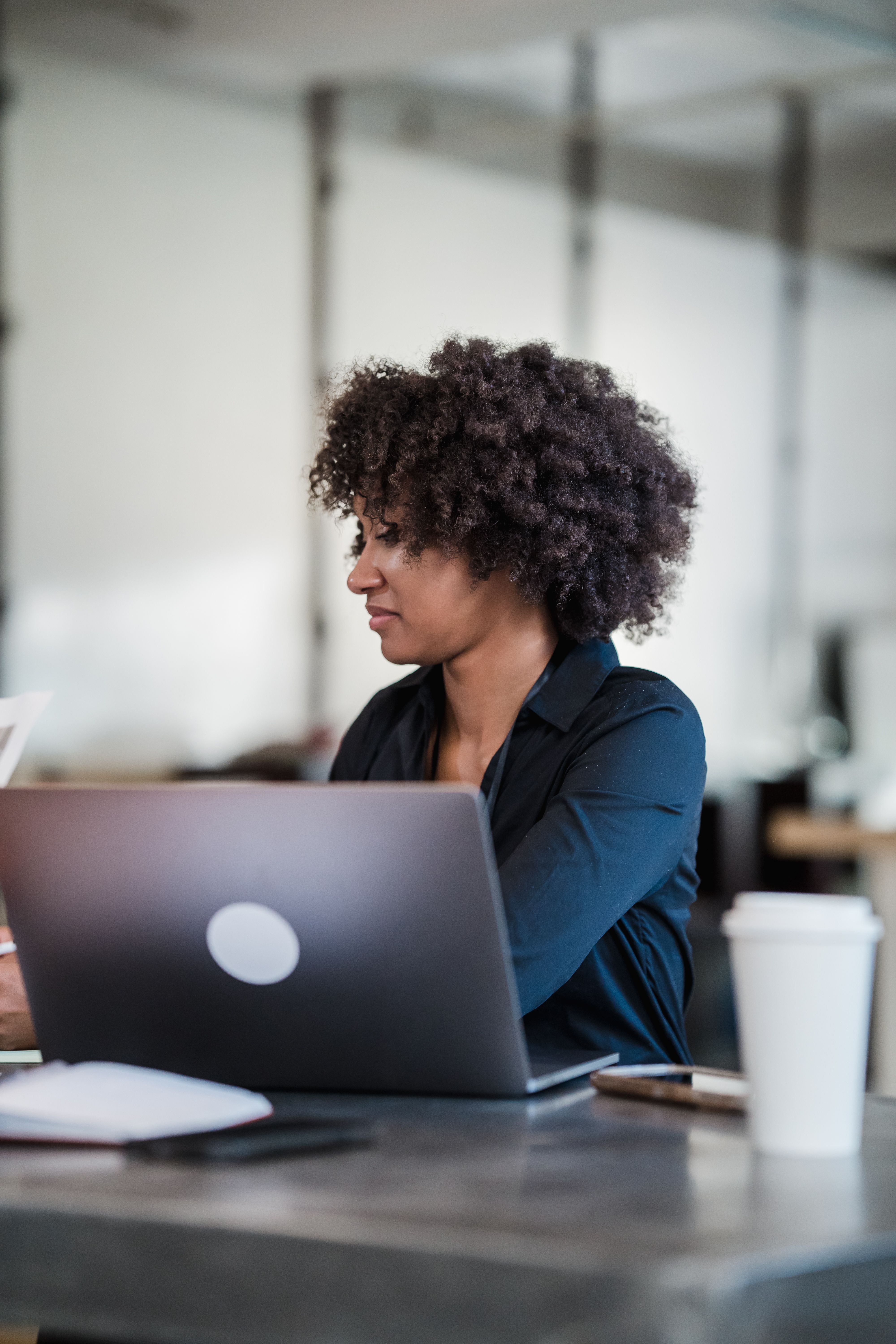 Woman in the Office Sitting in Front of Her Laptop · Free Stock Photo