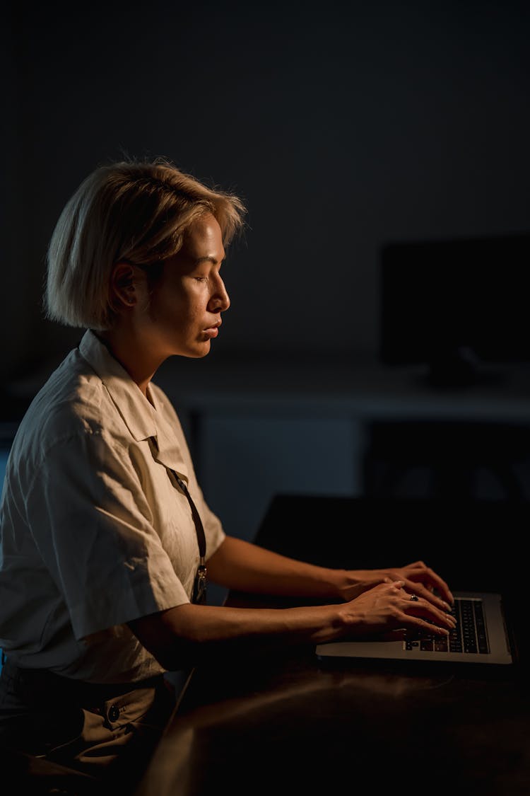 Serious Woman Working Late On A Laptop 