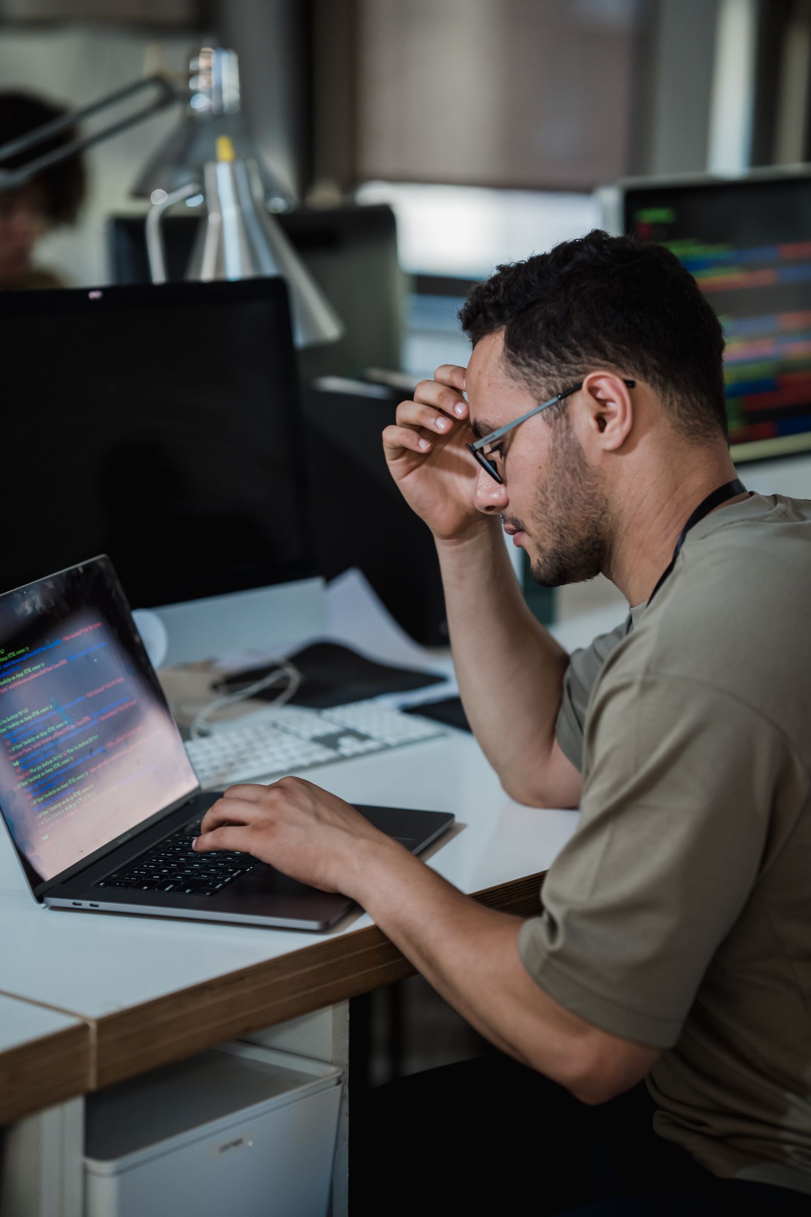 A developer concentrating on code at a bright desk