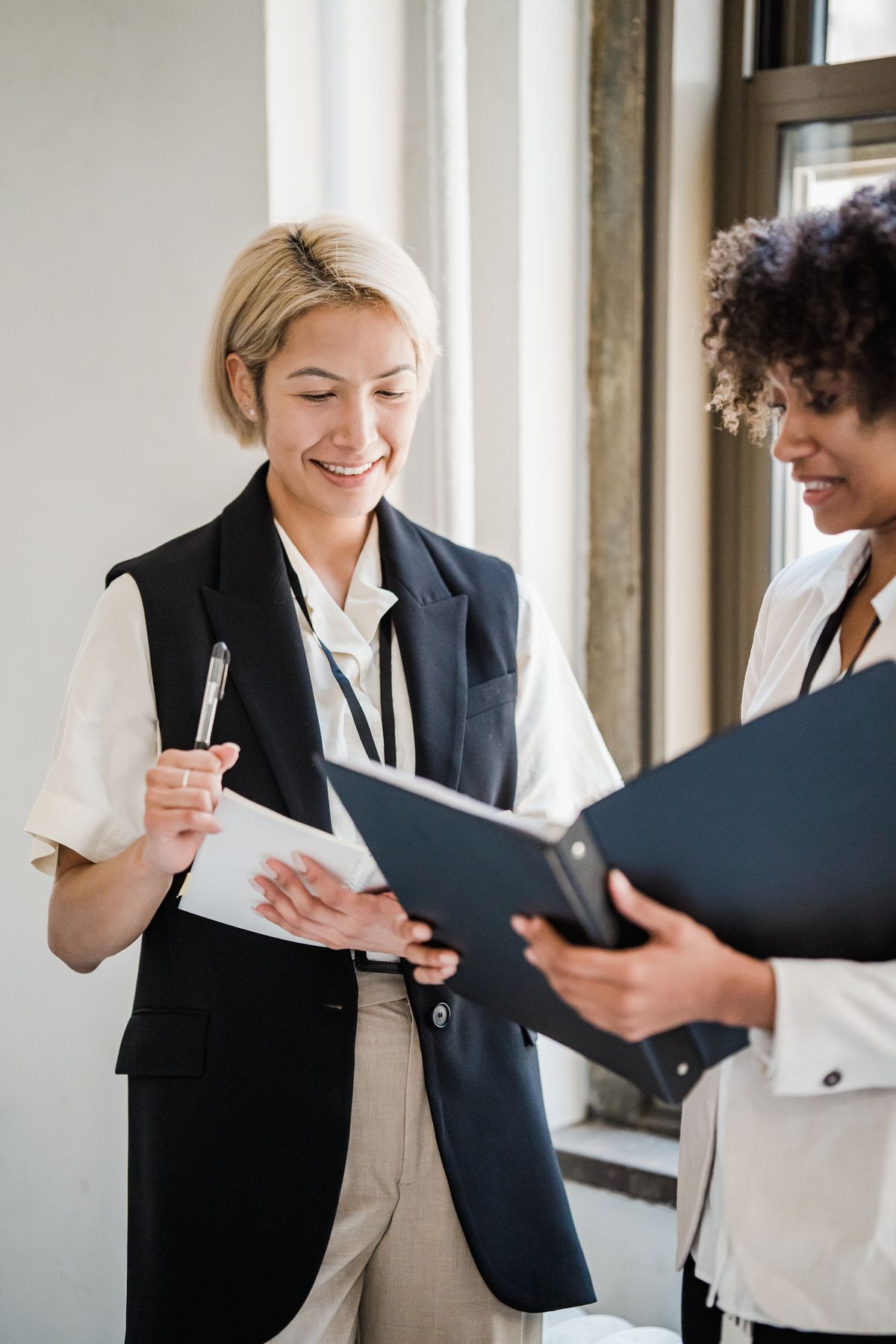 Two professionals reviewing information security documents