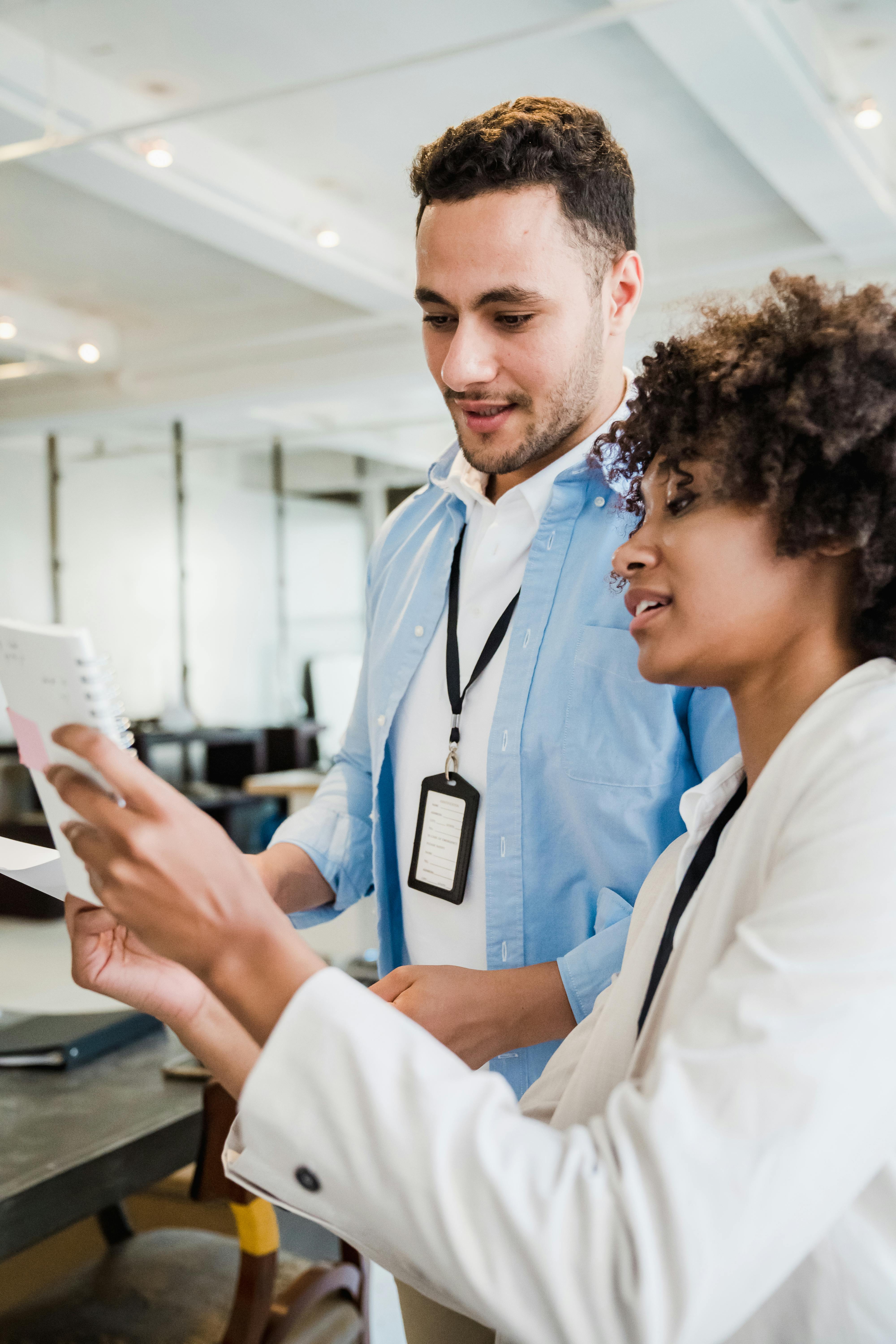 woman showing notes to a man in an office