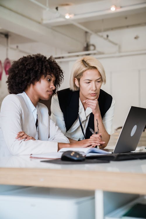 Two Women Using Laptop Together 