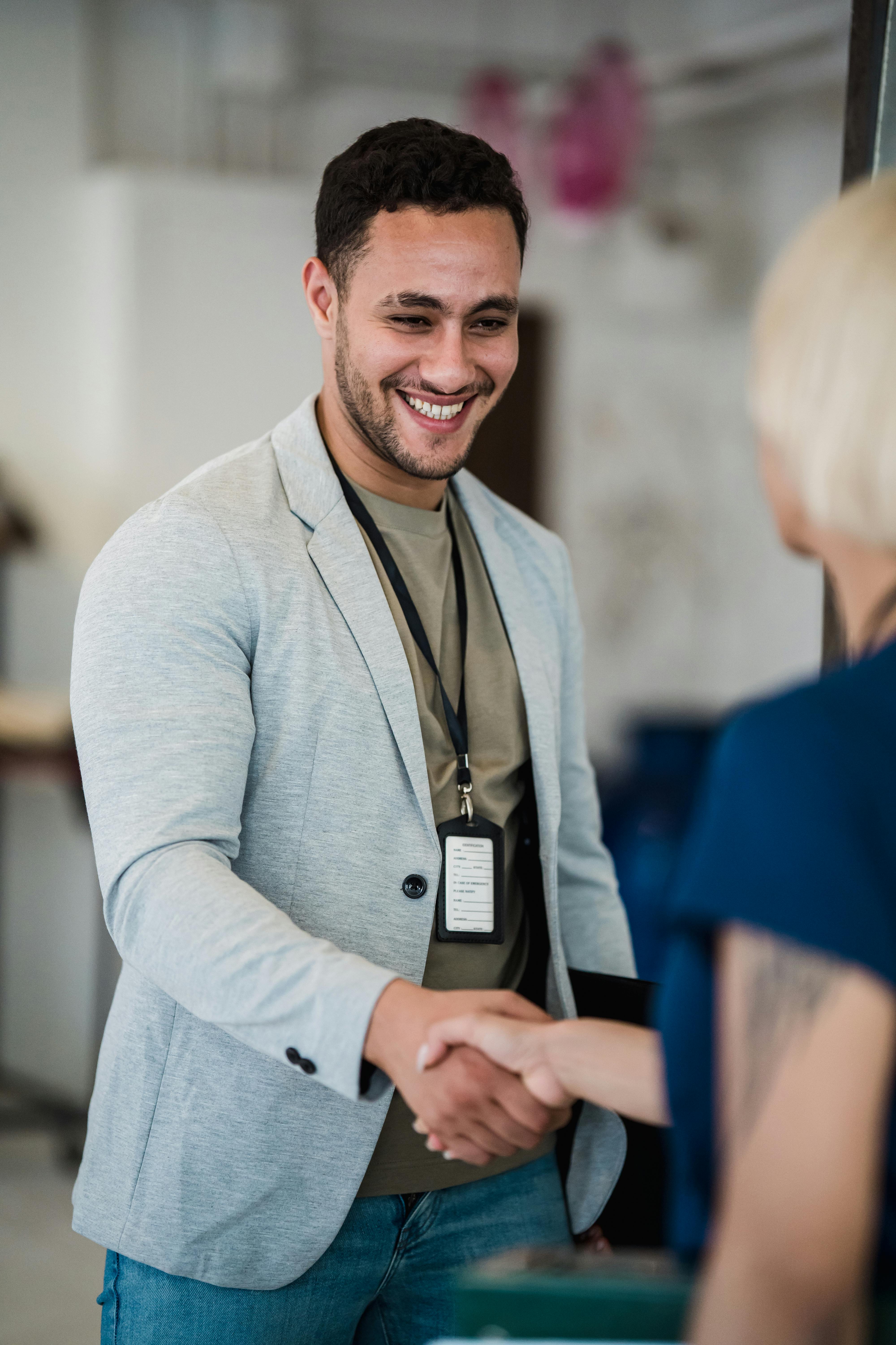 young man shaking hands with unrecognizable woman