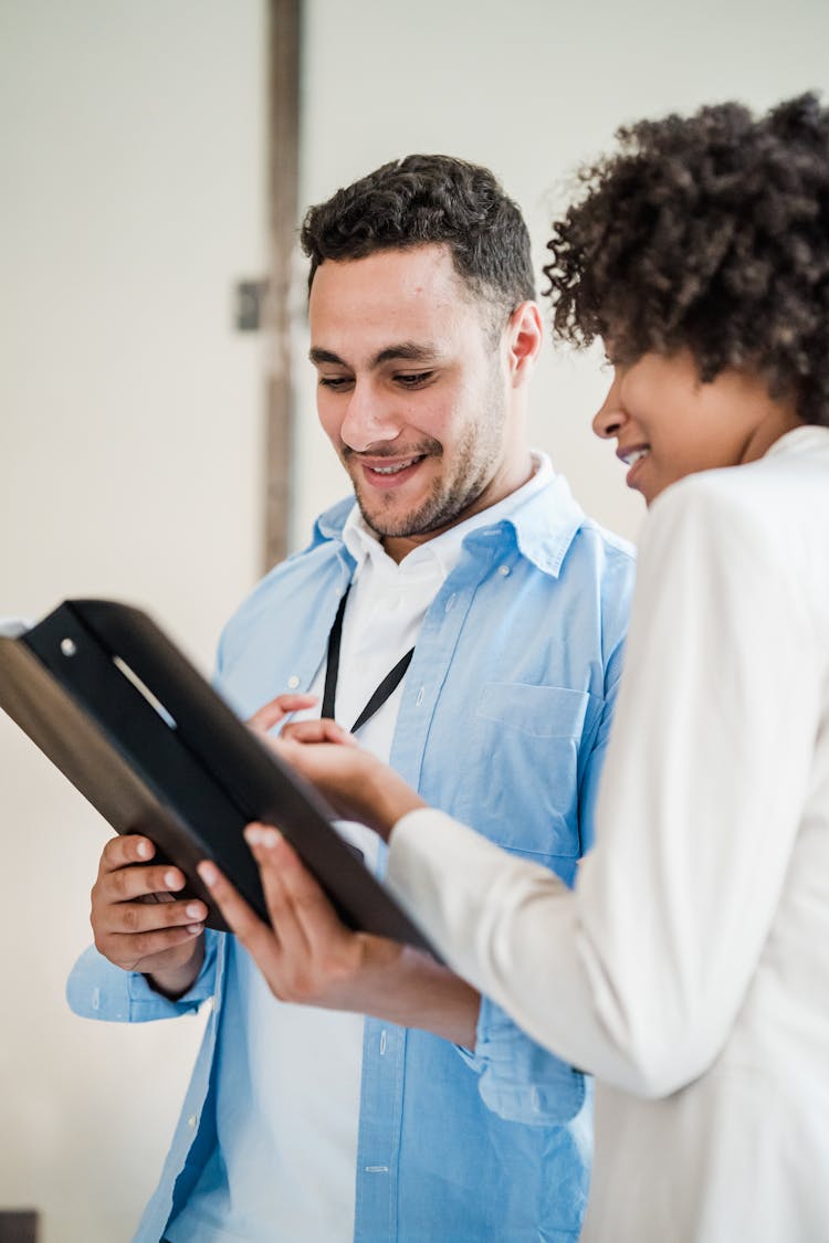 Man And Woman Looking At Documents In The Office 