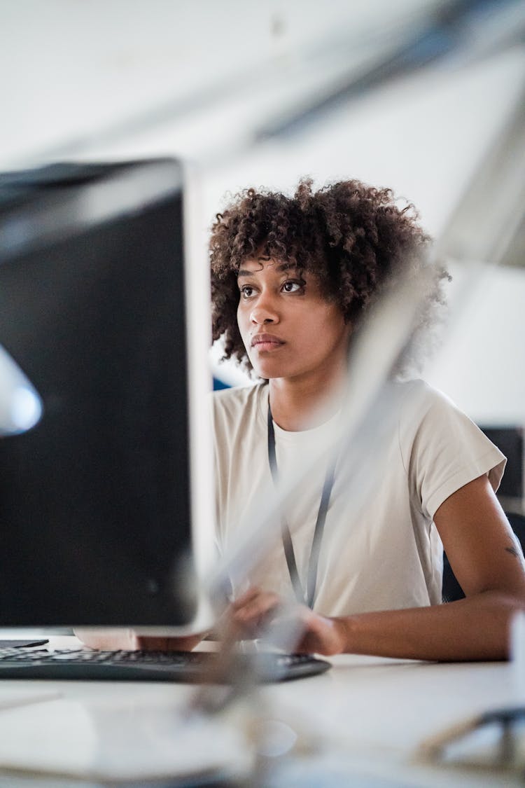 Young Woman Looking At PC Screen With Attention