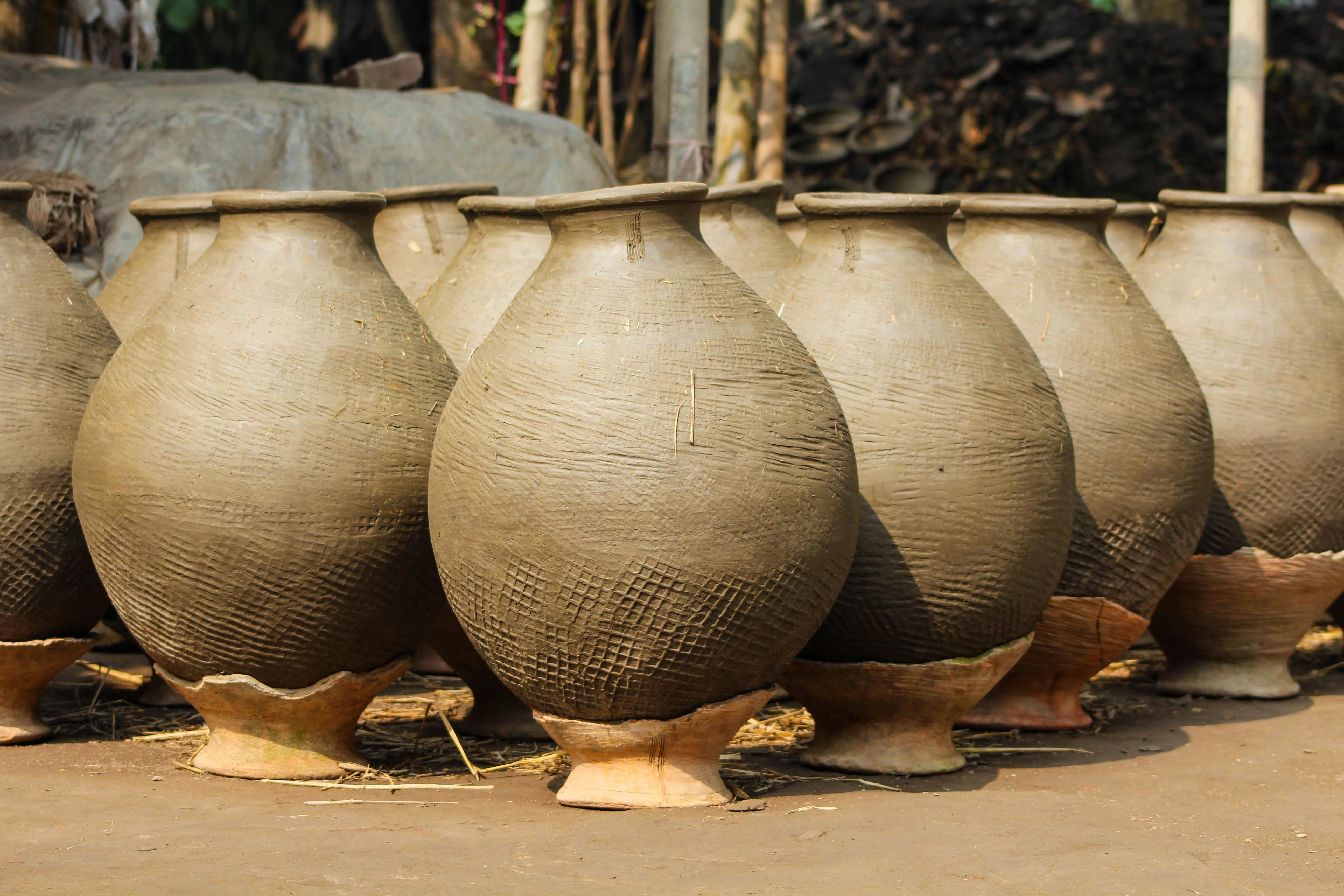 Earthenware Pots on Brown Ground · Free Stock Photo