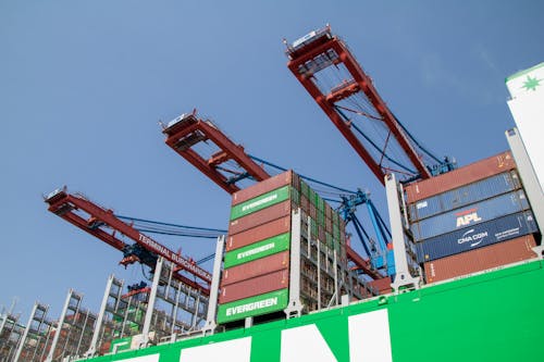 Low-Angle Shot of Harbour Cranes and Cargo Containers