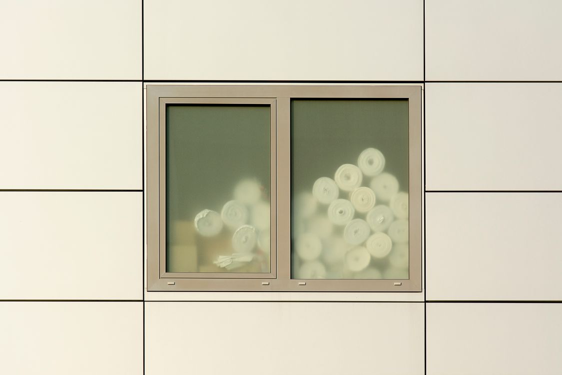 Rolled Objects Behind Glass Window · Free Stock Photo