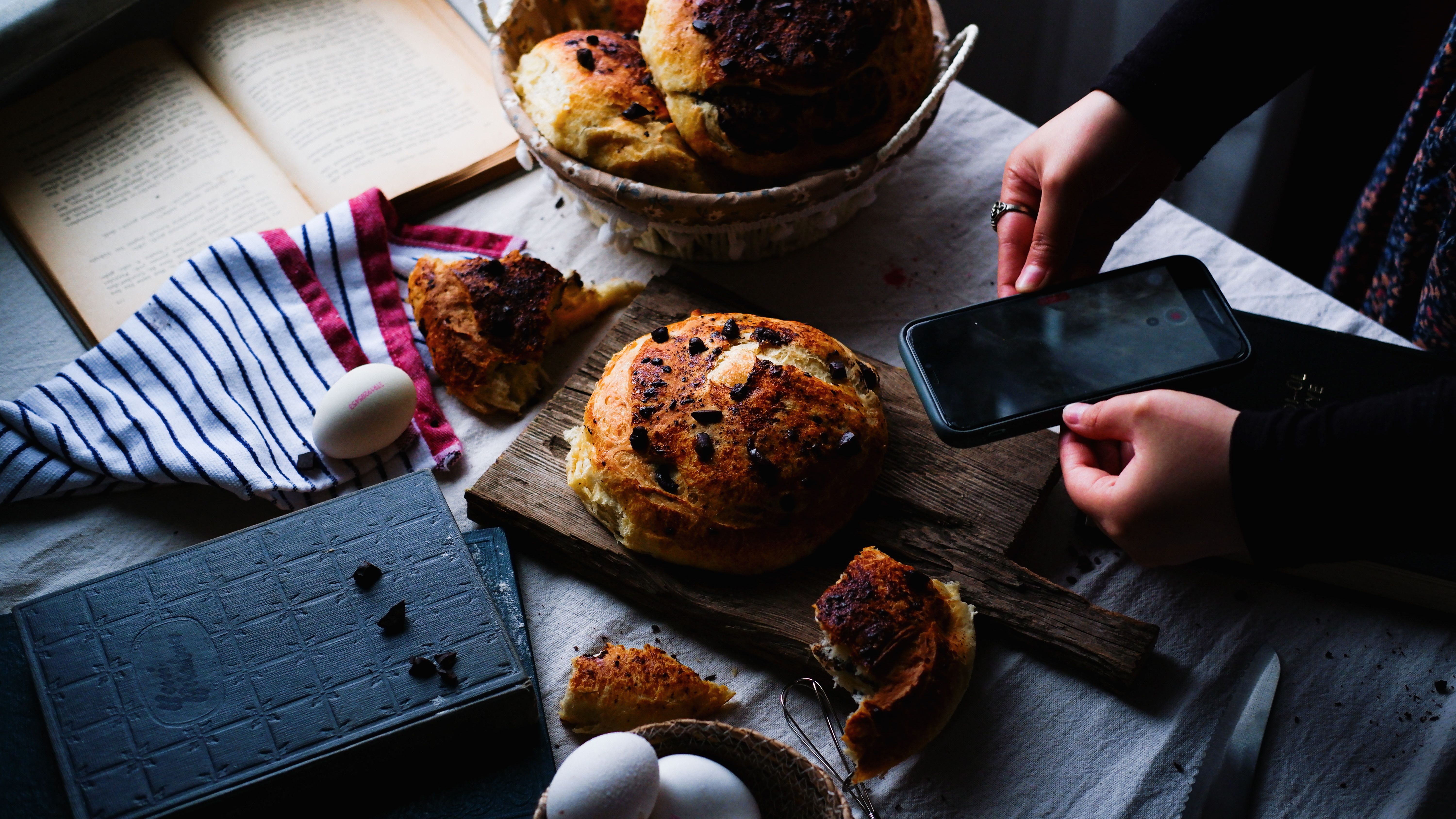 Homemade bread being photographed with a smartphone