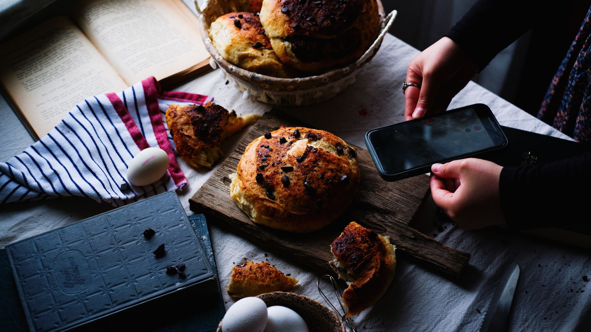 Homemade bread being photographed with a smartphone