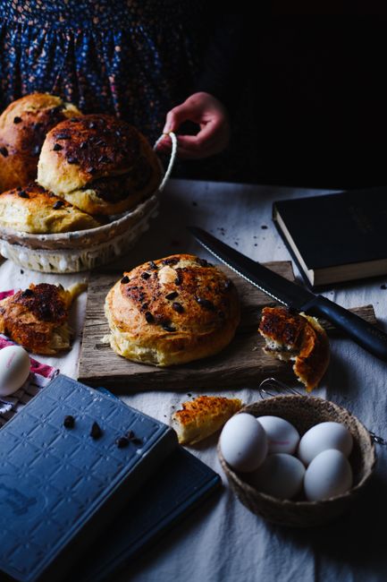 Artisan bread and raw eggs on a table with a vintage vibe, perfect for cozy culinary themes.