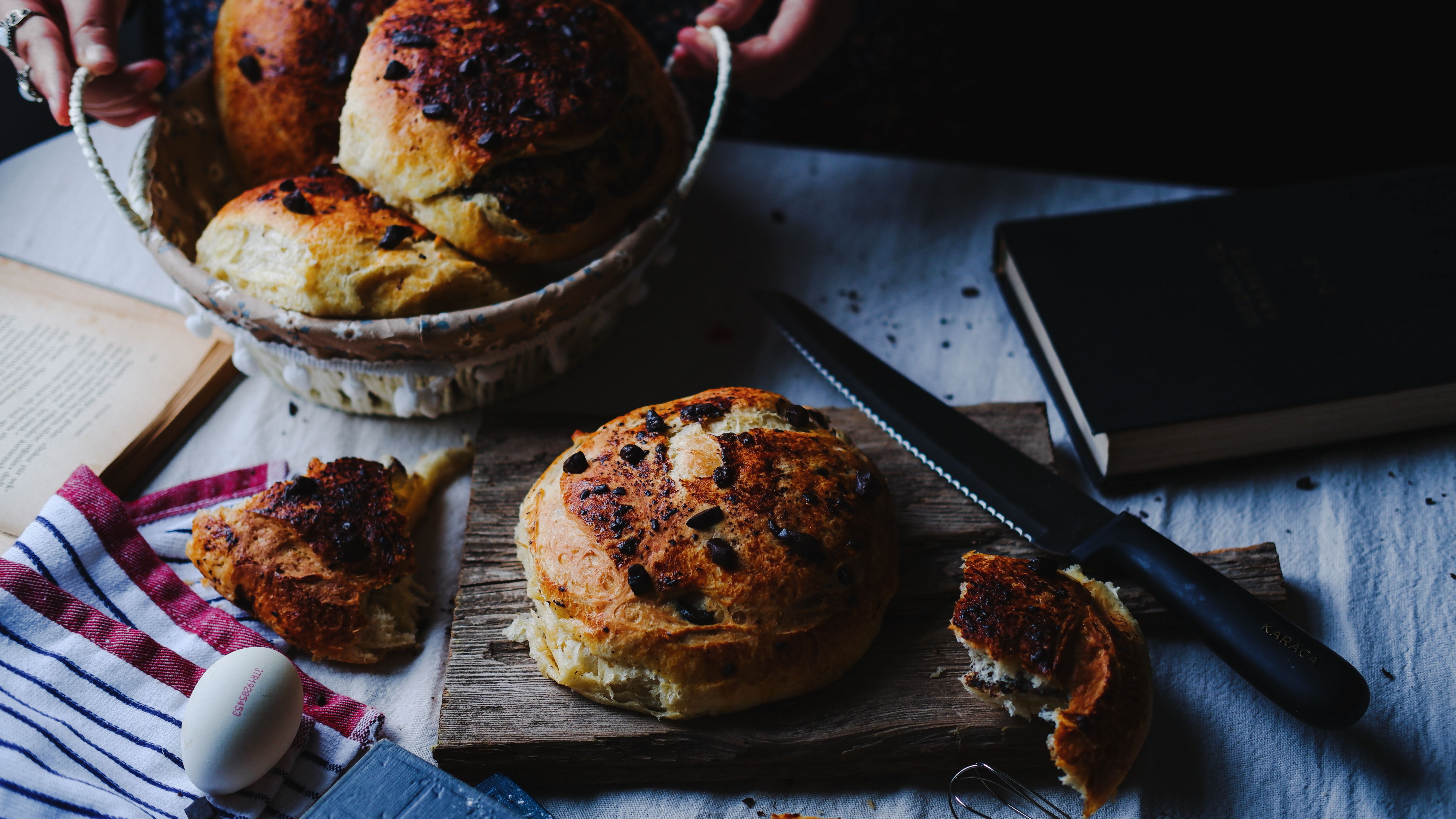 Sliced rustic bread served with butter and herbs