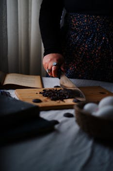 Close-up of a person chopping on a wooden board with kitchen ambiance.