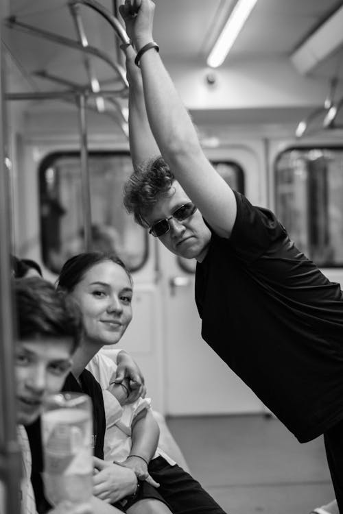 Grayscale Photo of People Riding a Train