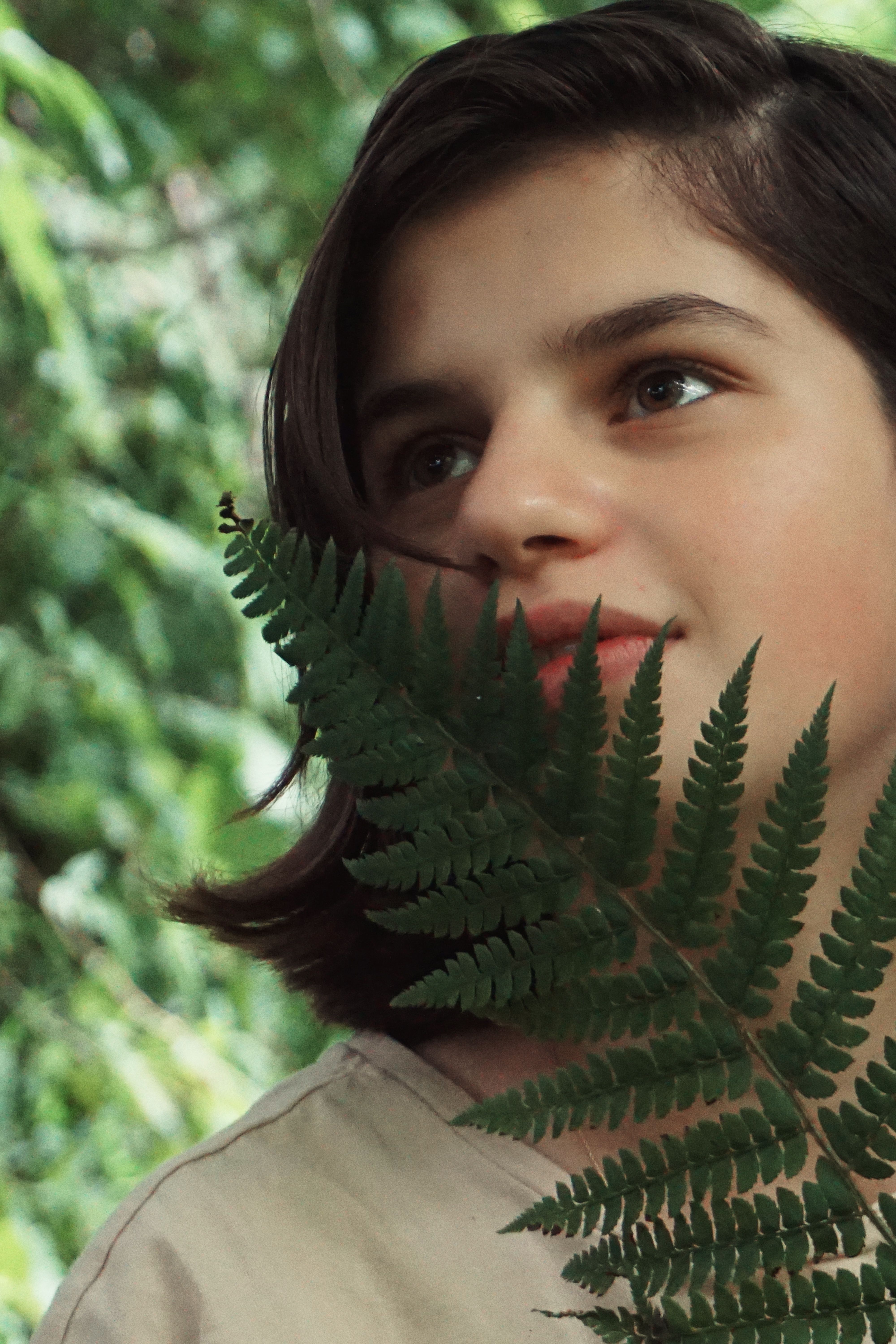Close-Up Shot of a Girl Holding a Green Fern Plant · Free Stock Photo