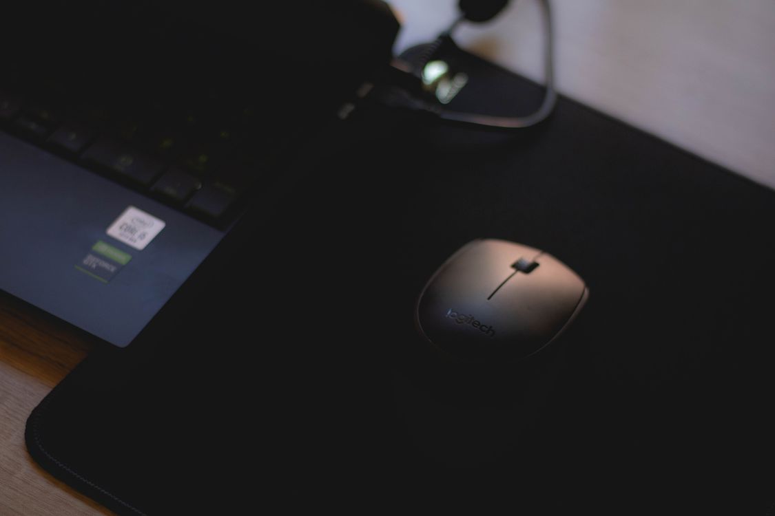 Black Logitech Mouse Near Laptop · Free Stock Photo
