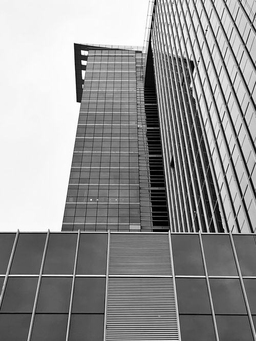 Free Striking grayscale image of a modern skyscraper viewed from below. Stock Photo