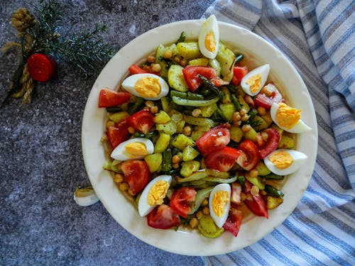 Free Delicious Vegetable Salad with Slices of Boiled Eggs Stock Photo
