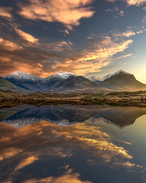 Free Mountains Reflected in a Lake at Sunset Stock Photo