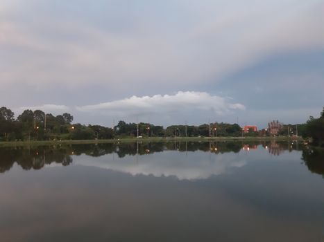 Beautiful evening scene with light reflections on the calm waters of Mueang Tai Lake, Thailand.