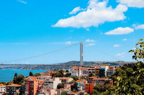 Free Vibrant cityscape featuring the Bosphorus Bridge against a clear blue sky. Stock Photo